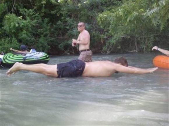 Man Using a Human Raft Optical Illusion